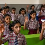 Students and teachers preparing classrooms for the new academic session in India.