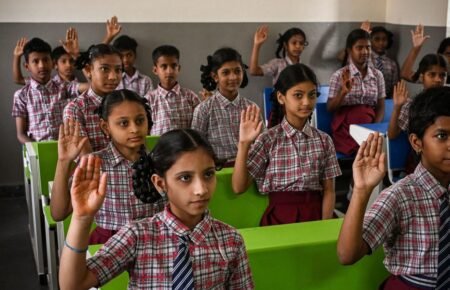 Students and teachers preparing classrooms for the new academic session in India.