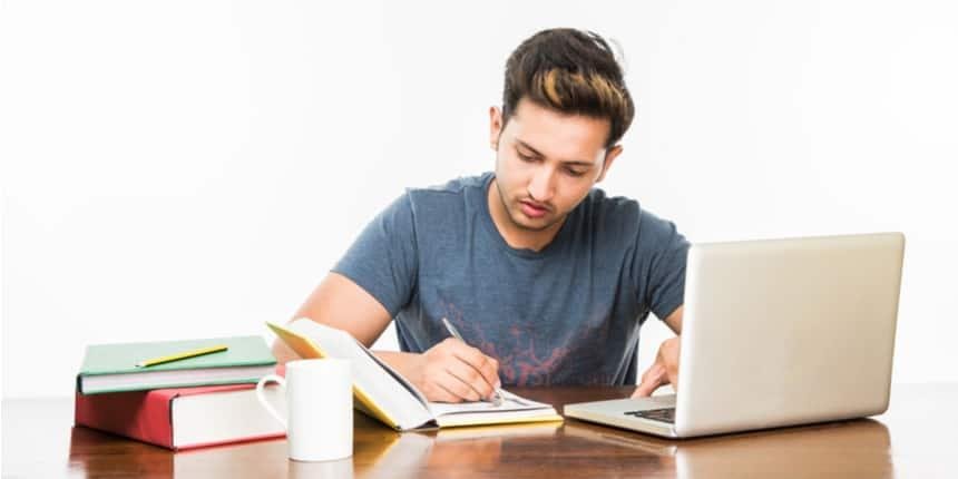 student studying JEE exam preparation admit card laptop books india