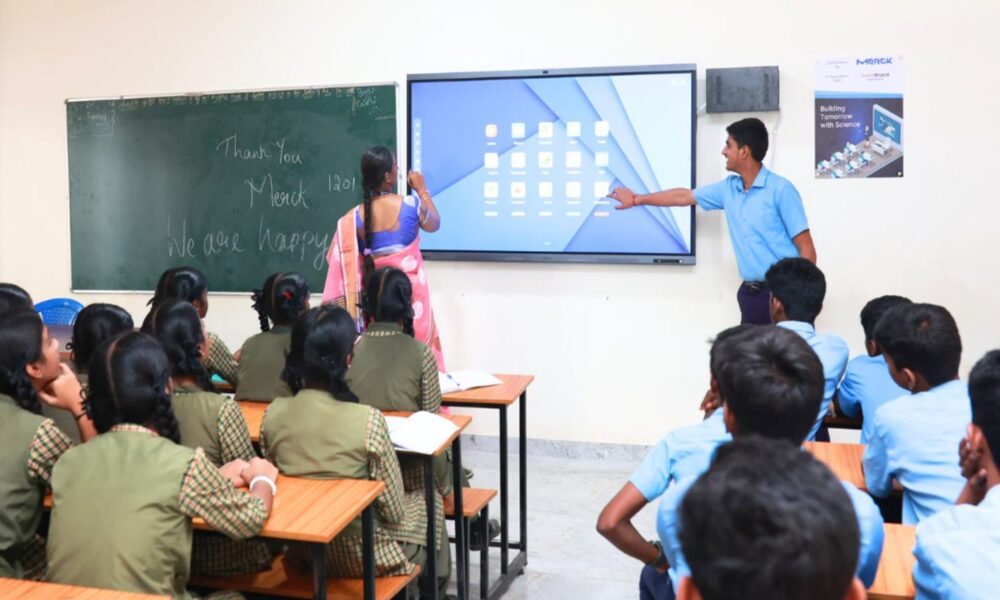 Students using digital learning tools in a smart classroom in India.