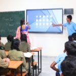 Students using digital learning tools in a smart classroom in India.