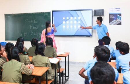 Students using digital learning tools in a smart classroom in India.