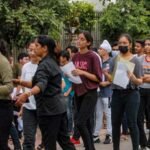 Students arriving for a university entrance examination in India.