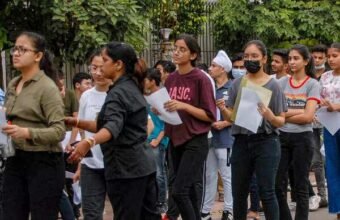 Students arriving for a university entrance examination in India.