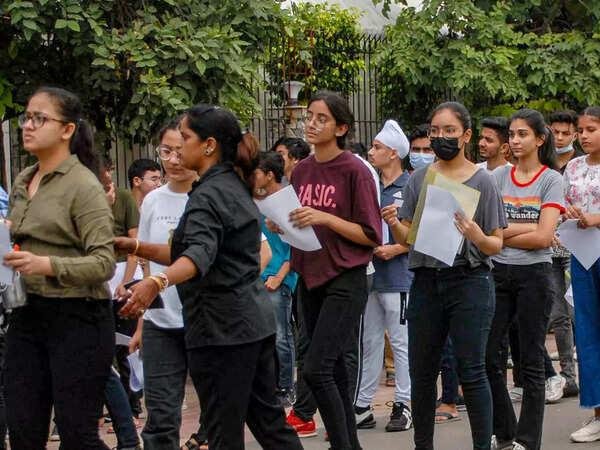 Students arriving for a university entrance examination in India.