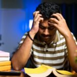 student stressed studying books exam pressure india late night study