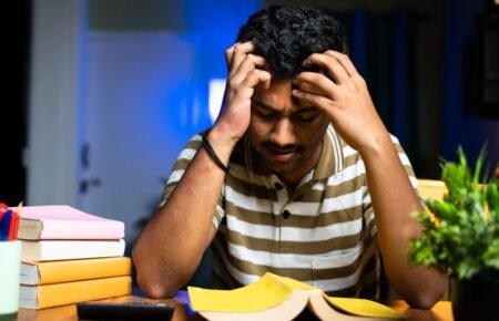 student stressed studying books exam pressure india late night study