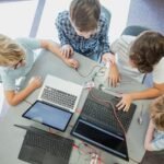 Alt Text: Students learning through digital classroom and skill education programmes in India.