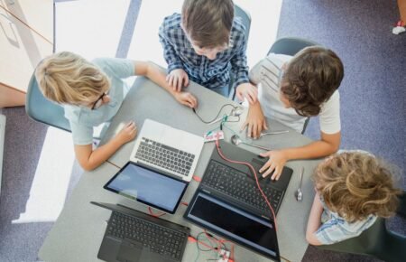 Alt Text: Students learning through digital classroom and skill education programmes in India.
