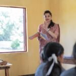 Teacher conducting a classroom session with students in an Indian school.
