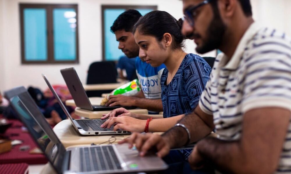 College students learning artificial intelligence and digital skills in a classroom setting.