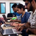 College students learning artificial intelligence and digital skills in a classroom setting.