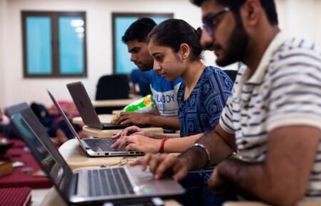 College students learning artificial intelligence and digital skills in a classroom setting.
