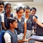 Students checking CBSE Class 12 examination results online.