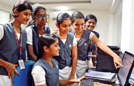 Students checking CBSE Class 12 examination results online.