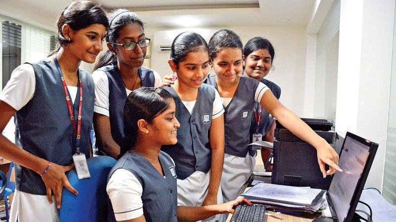 Students checking CBSE Class 12 examination results online.