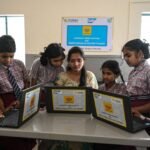 Students learning media literacy and digital information verification skills in a classroom.
