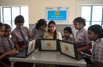 Students learning media literacy and digital information verification skills in a classroom.