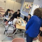Students participating in a financial literacy and money management session in a school classroom.