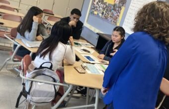 Students participating in a financial literacy and money management session in a school classroom.