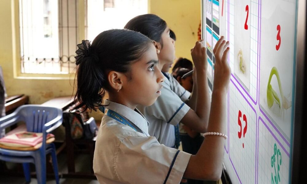 Students learning in a technology-enabled digital classroom.