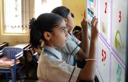 Students learning in a technology-enabled digital classroom.