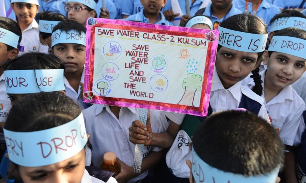 : Students participating in a water conservation awareness programme in a school