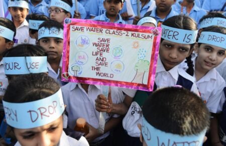 : Students participating in a water conservation awareness programme in a school