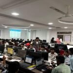 College students learning cybersecurity and information security concepts in a technology lab.