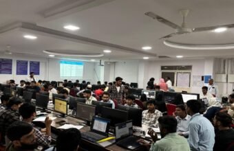 College students learning cybersecurity and information security concepts in a technology lab.