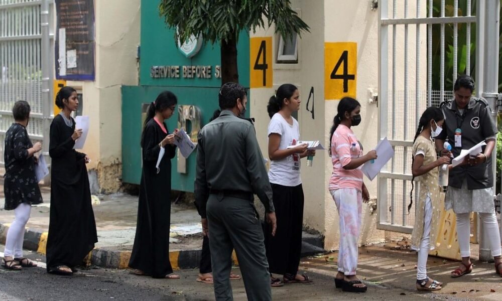Students arriving for a competitive entrance examination in India.