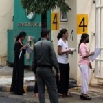 Students arriving for a competitive entrance examination in India.