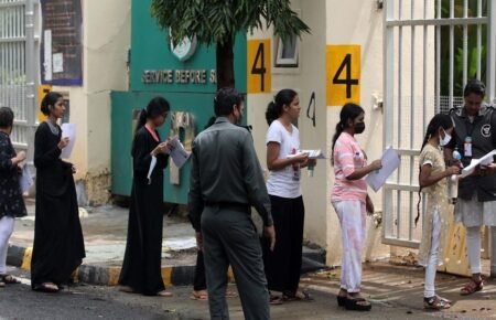 Students arriving for a competitive entrance examination in India.