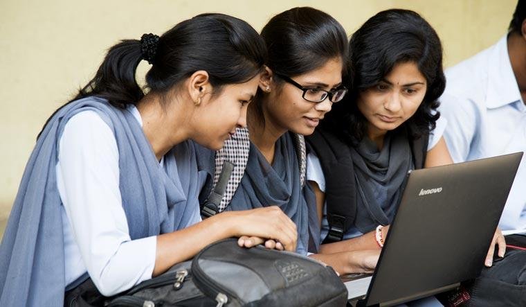 Students checking their Class 10 examination results online.