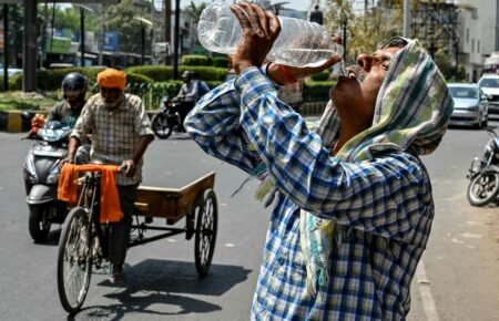 Healthcare professionals treating a patient affected by extreme heat.