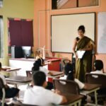 Teacher conducting a classroom session with students in an Indian school.