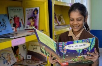 Primary school students participating in a reading activity in Uttar Pradesh.