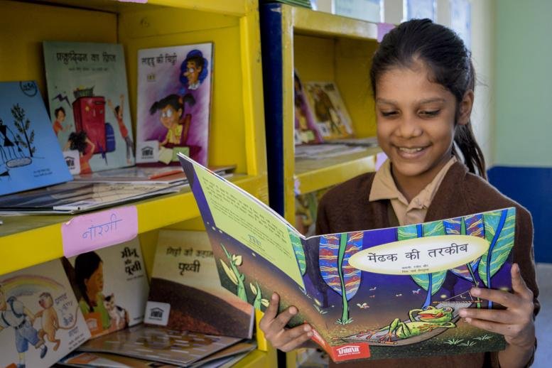 Primary school students participating in a reading activity in Uttar Pradesh.