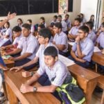 Students using newly designed textbooks in a secondary school classroom.