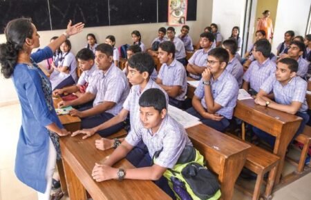 Students using newly designed textbooks in a secondary school classroom.