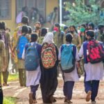 Students standing outside a school campus in Telangana during a temporary closure.