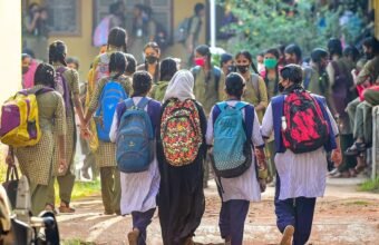 Students standing outside a school campus in Telangana during a temporary closure.