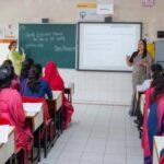 Students attending a teacher education programme in a college classroom.